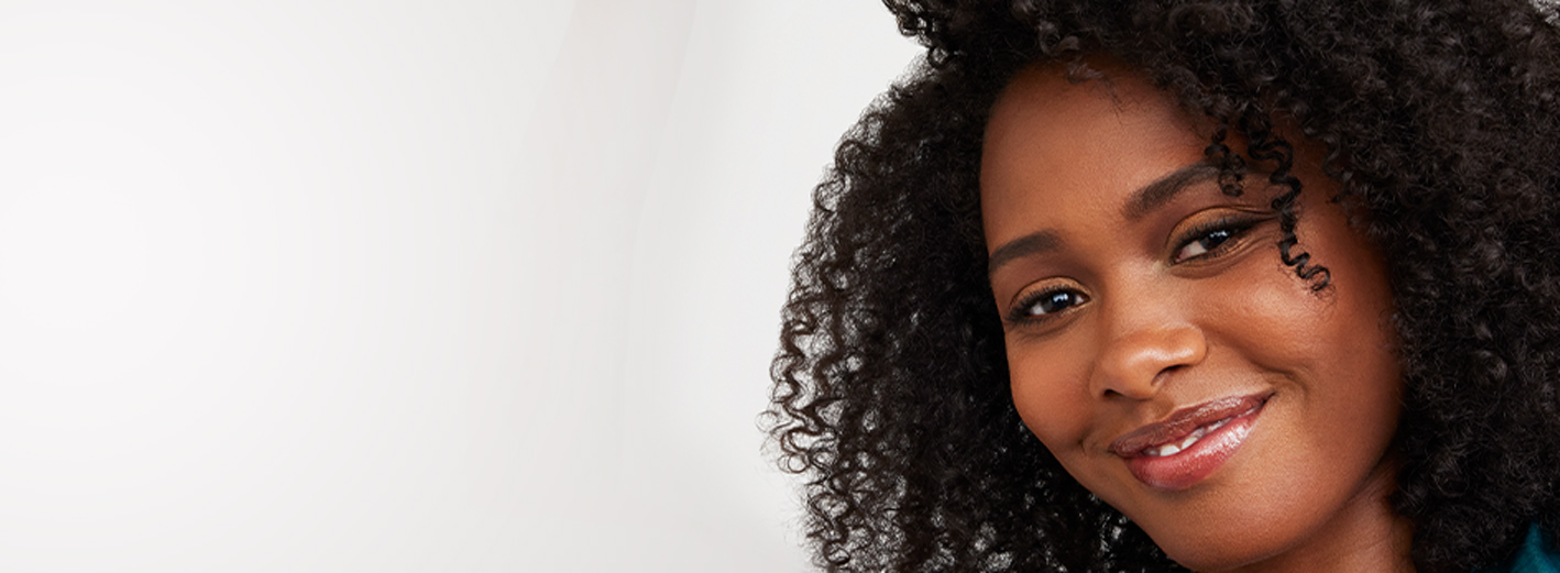 Close up of smiling model wearing The New Nudes makeup artist look