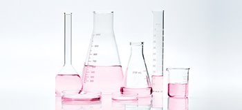 Scientific glass filled with pink liquid to represent Mary Kay research.