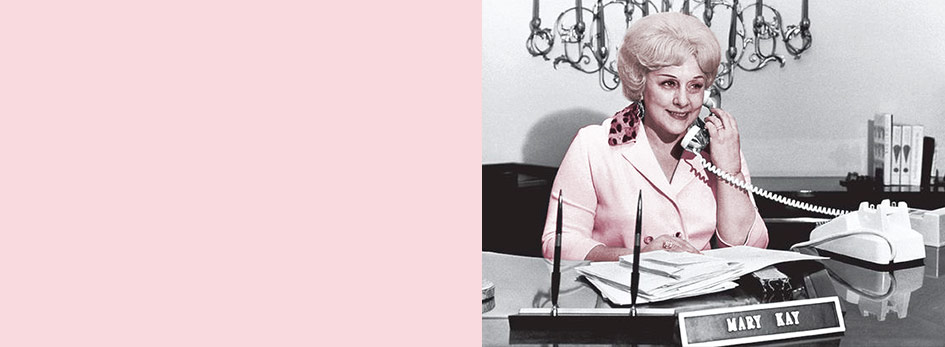 Mary Kay Ash stands in front of her first storefront for Beauty by Mary Kay, the origin of the Mary Kay company.