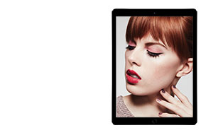 Try on a new holiday look using the Mary Kay Virtual Makeover. A red head young woman is shown in a tablet on the right side. She is wearing pink eye shadow and red lipstick. 