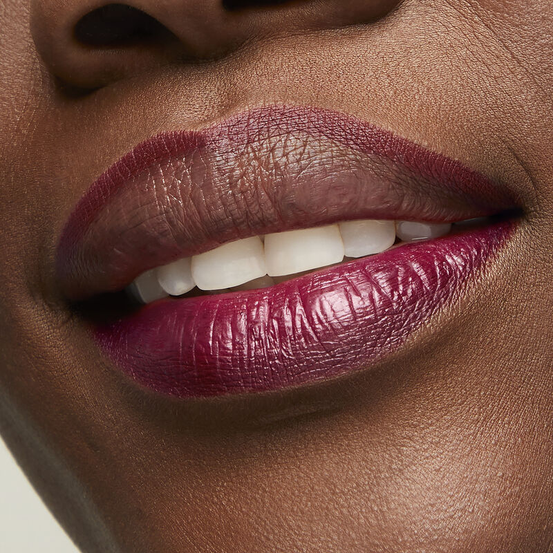 Deep skinned woman wearing Mary Kay Waterproof Lip Liner in Berry