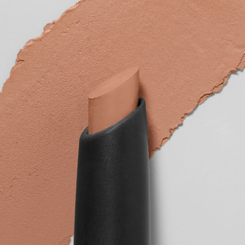 Mary Kay&reg; Matte&nbsp;Eye Shadow Stick in&nbsp;Celestial Nude, slanted tip in foreground, swatch in background.&nbsp;