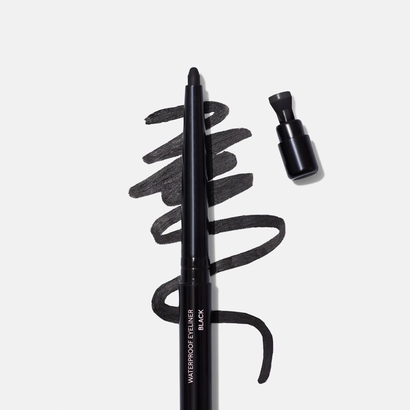 Uncapped Mary Kay Waterproof Eyeliner in Black against product rub next to sharpener cap