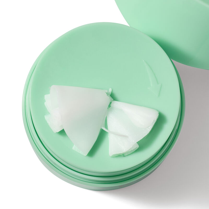 White Mary Kay MeltIn Cleansing Balm sitting on top of green jar