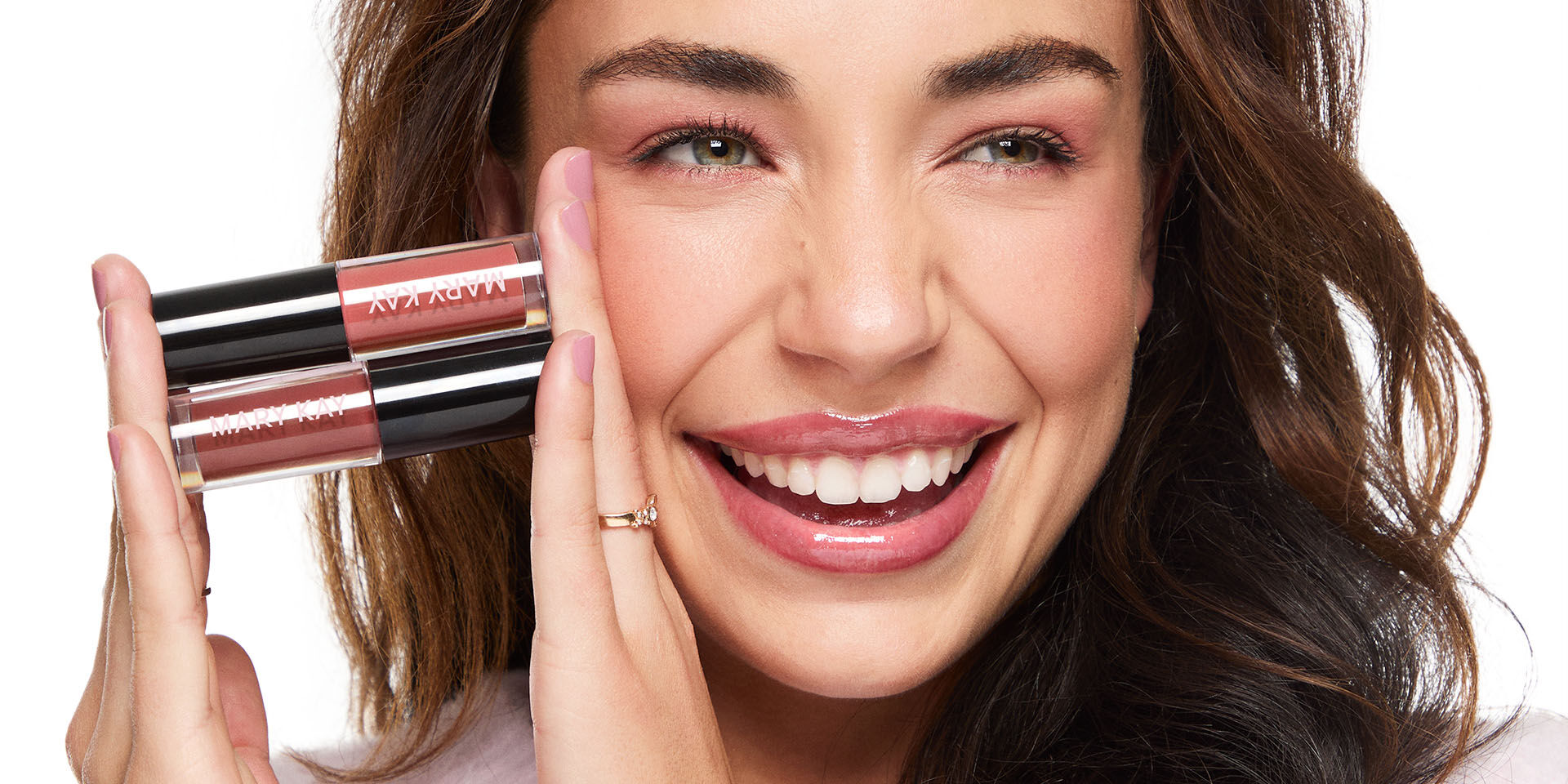 Woman smiling and holding Mary Kay Lip Oil